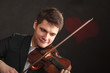 © Voyagerix - Man man dressed elegantly playing violin