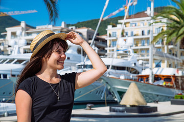 Wall Mural - smiling woman portrait at dock with yachts on background