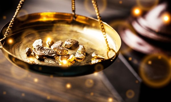 small gold nuggets in an antique measuring