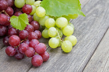 Fresh Red And Green Grapes On A Rustic Wooden Table