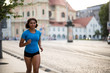© Martinan - Athletic teenager running on city street