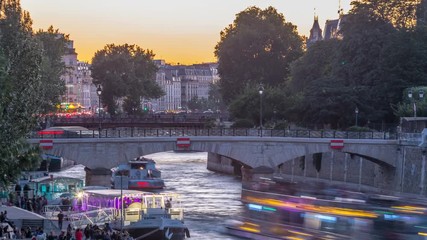 Wall Mural - River and bridge near Notre Dame De Paris cathedral day to night timelapse after sunset.