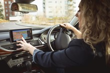 Female Executive Using Navigation While Driving A Car