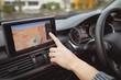 © Wavebreak Media - Close up of woman's hand using navigation in car
