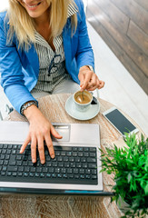 Businesswoman working with laptop during coffee break