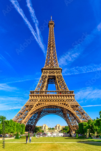 Obraz Dibond Paris Eiffel Tower and Champ de Mars in Paris, France. Eiffel Tower is one of the most iconic landmarks in Paris. The Champ de Mars is a large public park in Paris