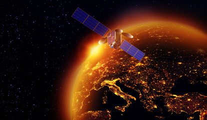 Wall Mural - satellite with a golden sunrise of the sun above the earth