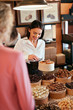 © puhhha - Chocolate Shop. Woman Selling Chocolate Sweets And Candies