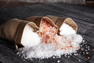 sea salt and himalayan in burlap. crystals of salt on table