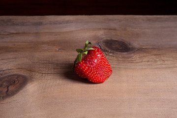 Strawberry fresh ripe sweet berry on wooden background.