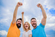 © be free - We can do it. Woman and men look successful celebrate victory sky background. Threesome stand happy with raised fists. Behaviors of winner team. Celebrate success. Ways to build successful team