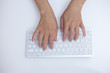 © manusapon - women's hands are typing on laptop's keyboard.