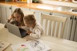 © Wavebreak Media - Children using laptop together in kitchen