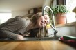 © Wavebreak Media - Young girl drinking water from tap in kitchen