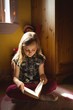 © Wavebreak Media - Girl reading book in bedroom at home