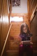 © Wavebreak Media - Girl using tablet on stair at home