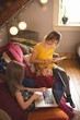 © Wavebreak Media - Family on sofa using multimedia devices