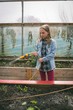 © Wavebreak Media - Girl watering saplings in greenhouse