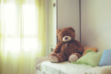 Childrem Room With A Brown Teddy Bear On The Bed