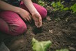 © Wavebreak Media - Girl planting seed in greenhouse