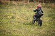 © Wavebreak Media - Kid riding a bike in garden