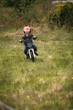 © Wavebreak Media - Kid riding a bike in garden
