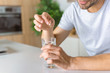 © LIGHTFIELD STUDIOS - cropped image of man putting pill into glass with water at kitchen table