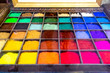 An art  tray full of colourful pigment used to make paints, all colours of the rainbow, color, colorful