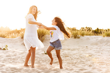 Wall Mural - Cute family having fun together outdoors at the beach.