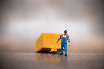 Miniature people, man pulling paper box using for logistic and business concept