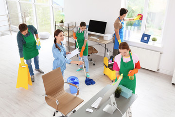 Wall Mural - Team of professional janitors in uniform cleaning office