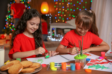 Wall Mural - Little children painting pictures at home. Christmas celebration