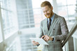 © BGStock72 - Confident businessman using tablet on office stairs