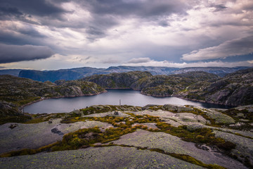 Wall Mural - Norway- July 31, 2018: Traveler in the landscape near the Kjerag rock, Norway