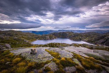 Wall Mural - Norway- July 31, 2018: Traveler in the landscape near the Kjerag rock, Norway