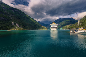 Wall Mural - Geiranger - July 30, 2018: Cruise boat in the UNESCO town of Geiranger, Norway