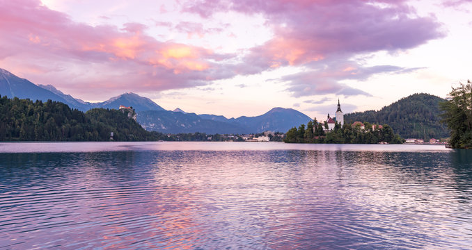 Mystic and magic sunset above the Bled lake, Slovenia. Beautiful magic purple colors and peaceful lake with church on the island. Magic sunset above the Alps.