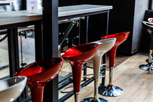 Left Side Of A Row Of Red And Pink Square Bar Stools