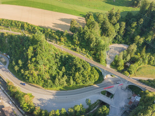 Wall Mural - Aerial view of railroad bridge crossing road in Switzerland