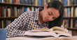 © Mark Adams - Hardworking Latina student studies for a class in her school library