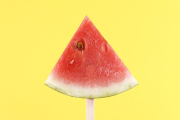 Watermelon slice on a stick.