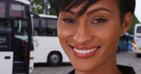 Wall Mural - African woman in Paris France looking at camera happily at tour bus stop