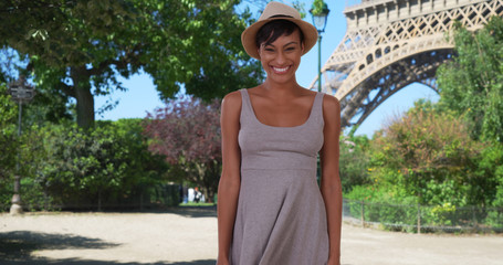 Wall Mural - Confident black woman expressing happiness in front of Eiffel Tower in Paris