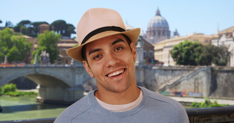 Happy attractive Latino male on vacation in Rome smiling and laughing