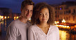 © Mark Adams - Happy millennial couple pose for a portrait by the Grand Canal in Venice Italy