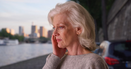 Sad stressed woman on vacation in Paris looking at river Seine