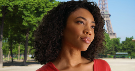 Poster - Carefree black girl thinking peacefully to herself by Eiffel Tower in Paris