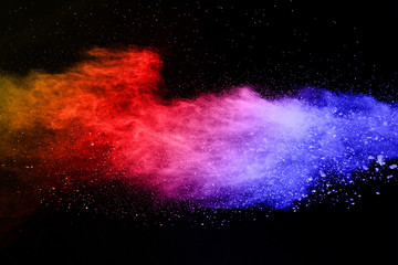 abstract colored dust explosion on a black background.abstract powder splatted background,Freeze motion of color powder exploding/throwing color powder, multicolored glitter texture.