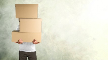 Wall Mural - Delivery man carrying stacked boxes in front