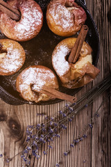 Wall Mural - Baked apples with cinnamon sticks in cast iron skillet